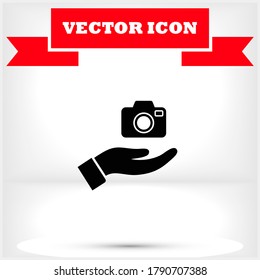 Camera in hand icon , lorem ipsum Flat design