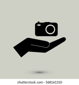 Camera in the hand icon, photo vector illustration