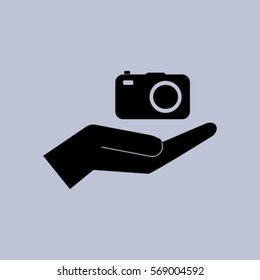 Camera in the hand icon, photo vector illustration