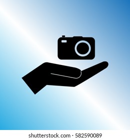 Camera in the hand icon, photo vector illustration