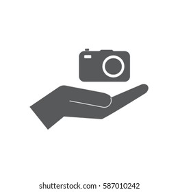 Camera in the hand icon, photo vector illustration