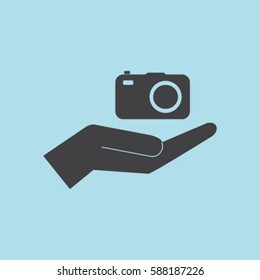 Camera in the hand icon, photo vector illustration