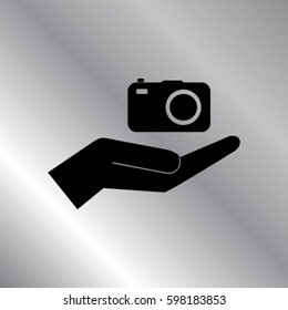 Camera in the hand icon, photo vector illustration