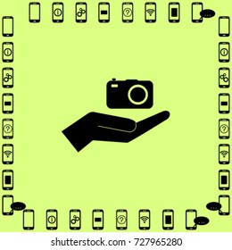 Camera in the hand icon, photo vector illustration