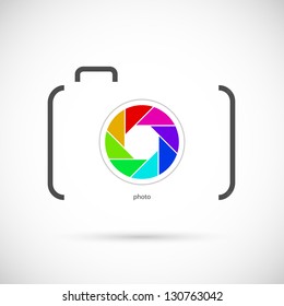 Camera icon with colorful lens. Outline shape.