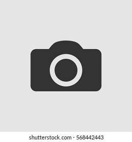 Camera icon flat. Black pictogram on grey background. Vector illustration symbol