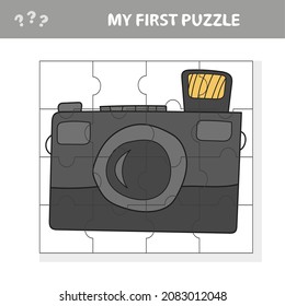 Camera with a lens. Education paper game for preshool children. Vector illustration. Jigsaw puzzle. My first puzzle