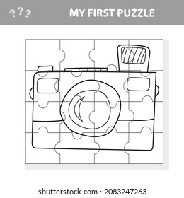 Camera with a lens. Education paper game for preshool children. Vector illustration. Jigsaw puzzle. My first puzzle and coloring page
