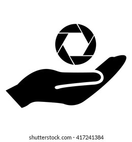 Camera lens icon in hand