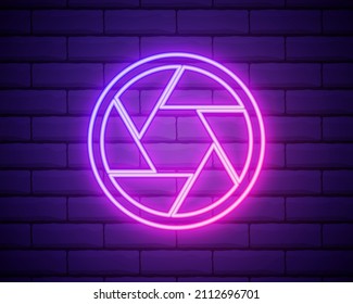 camera objective. simple silhouette. Neon style. Light decoration icon. Bright electric symbol isolated on brick wall
