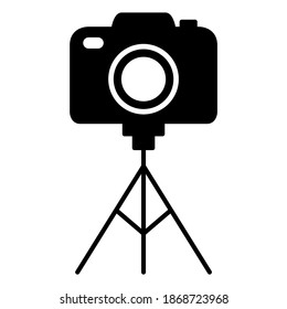 Camera on stand tripod icon in trendy silhouette style design. Vector illustration isolated on white background.