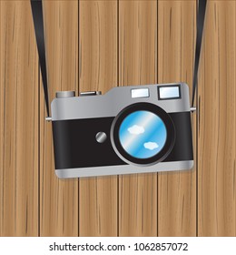 Camera on wooden and sky 