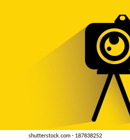 camera on yellow background, shadow and flat style