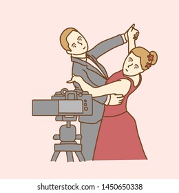 Camera recording a young couple blogger dancing while making a video
