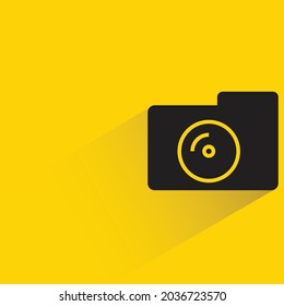 camera with shadow on yellow background