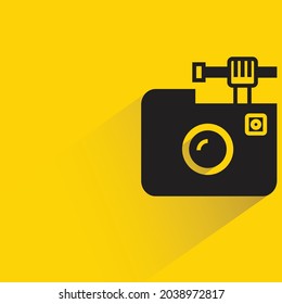 camera with shadow on yellow background