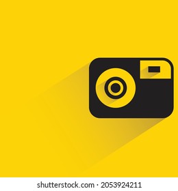camera with shadow on yellow background