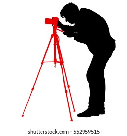 Cameraman with video camera. Silhouettes on white background. Vector illustration.