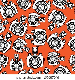cameras on red background seamless pattern