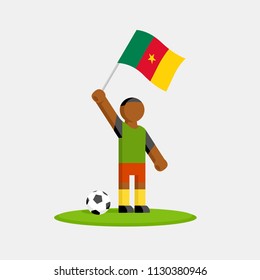 Cameroon soccer player in kit with flag and ball