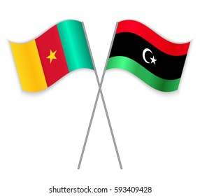 Cameroonian and Libyan crossed flags. Cameroon combined with Libya isolated on white. Language learning, international business or travel concept.