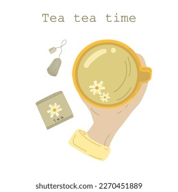 Camomile tea in a cup with hand