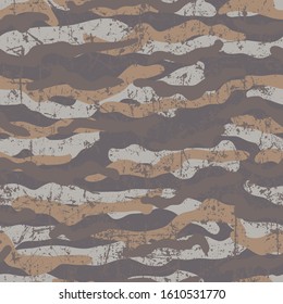 Camouflage seamless pattern. Grunge and scratch texture. Tan, ocher and two shades of brown.