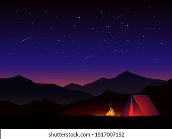 camp with fire in starry night at mountain 