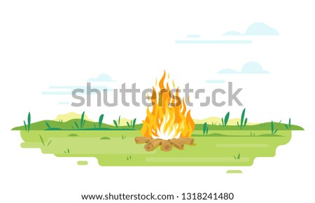 Campfire with long flames on green lawn, travel concept background in summer day with green grass isolated