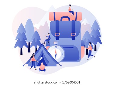 Camping concept. Nature tourism. Tiny people in summer camp with big travel backpack, tent, campfire, mountains and forest. Modern flat cartoon style. Vector illustration on white background