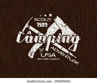 Camping emblem with shabby texture. Graphic design for t-shirt. White print on wood texture background