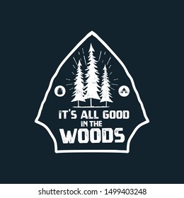 Camping graphic for T-Shirt, prints. Vintage hand drawn forest patch emblem. Retro summer travel landscape, unusual badge - It is all good in the woods phrase. Outdoors Adventure Label. Stock vector.