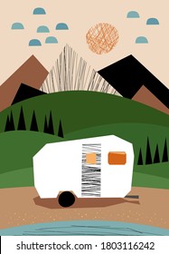 Camping trailer on the river bank in the mountains