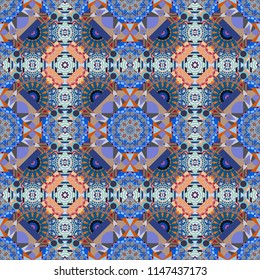 It can be used in the design of textiles, in the printing industry. Vector illustration. Kaleidoscopic seamless pattern in gray, blue and orange colors.