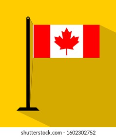 canada flag on pole, isolated on yellow background