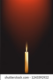 A candle is burning in the dark