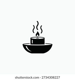 A candle burns steadily in a simple black bowl, viewed from directly above, serene, peaceful ambiance.