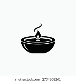 A candle burns steadily in a simple black bowl, viewed from directly above, serene, peaceful ambiance.