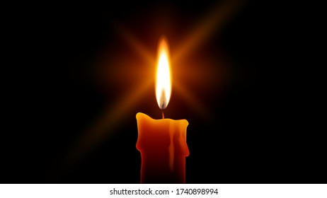 Candle flame burning in the dark. Yellow candle isolated on black background. Fire with a stars bursts lens flare