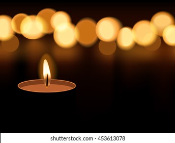 Candle light burning with candle flame bokeh on dark background