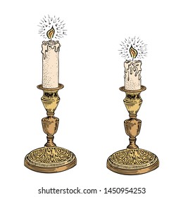 Candle sketch set. Hand drawn vector illustration of a burning candle with rays of light in vintage style