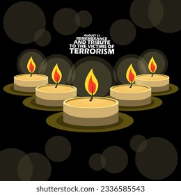 Candles burning in the dark with bold text on black background to commemorate International Day of Remembrance and Tribute to the Victims of Terrorism on August 21