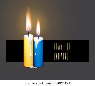 Candles flag colors for remembering day isolated on black background. Pray for Ukraine