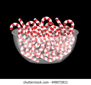 Candy cane in bowl. Peppermint stick deep in transparent plate. Sweets for New Year. traditional Lollipops for holiday. Mint Christmas 