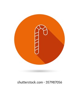 Candy cane icon. Sugar lollipop sign. Sweet lolly pop symbol. Round orange web button with shadow.