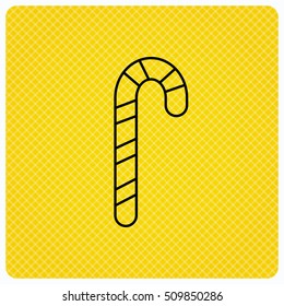 Candy cane icon. Sugar lollipop sign. Sweet lolly pop symbol. Linear icon on orange background. Vector