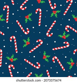 Candy Cane and mistletoe seamless pattern on darkblue backgound. Christmas decoration.