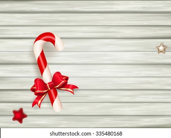 Candy cane on weathered wooden board. EPS 10 vector file included