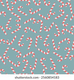 Candy cane. Randomly scattered sweets. Seamless vector pattern. Repeating Christmas ornament of striped red and white lollipops. Isolated greenish background. Flat style. Idea for web design.