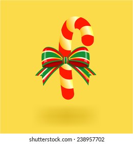 Candy cane with ribbon, with shadow isolated on yellow background. Vector illustration